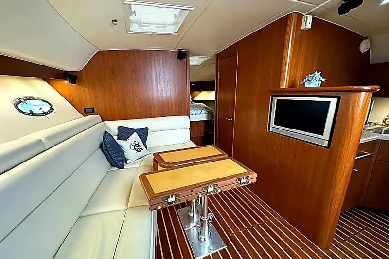 Slide: The Image of Luxurious 2004 Tiara Yachts 4200 Open interior with elegant wood finish and cozy seating. - 2