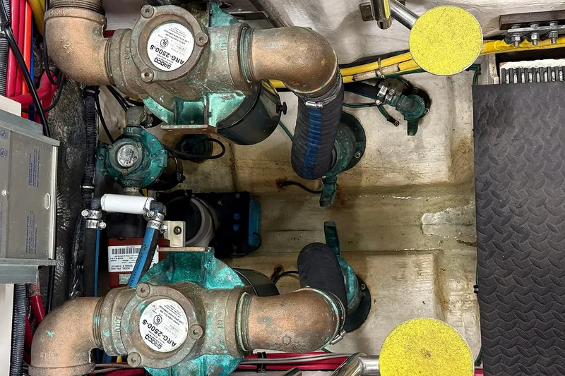 Slide: The Image of Engine room of a 2004 Tiara Yachts 4200 Open, showcasing mechanical components and piping. - 22