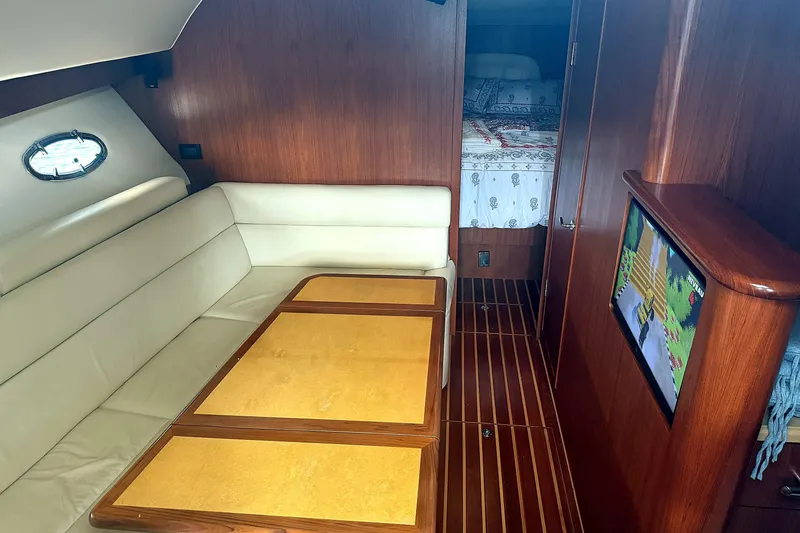 Slide: The Image of Interior of 2004 Tiara Yachts 4200 Open with leather seating and wood accents. - 6