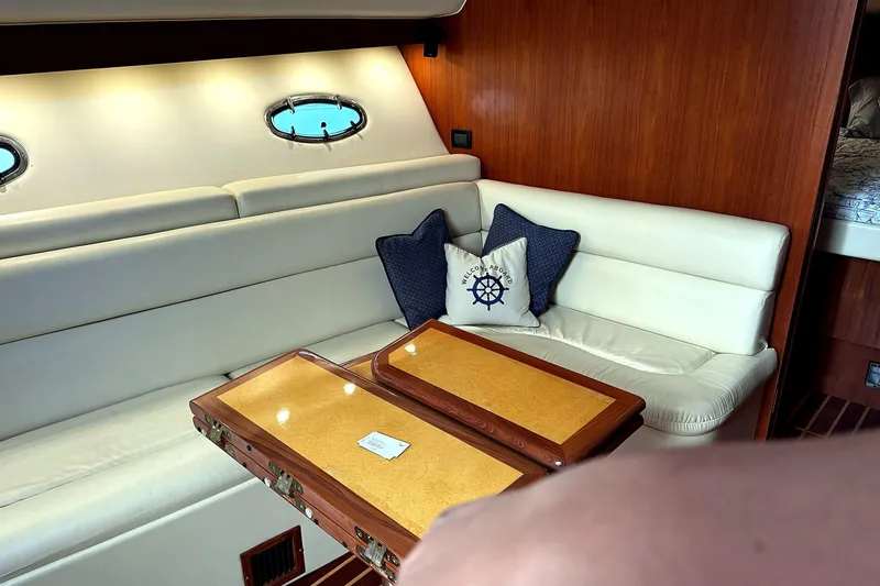 Slide: The Image of Interior of 2004 Tiara Yachts 4200 Open with cozy seating and nautical decor. - 9