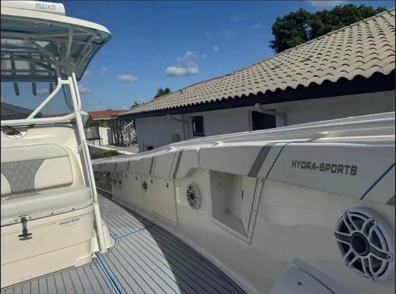 Slide: The Image of 2004 Hydra-Sports Vector 33 CC boat docked near a house under a clear blue sky. - 5