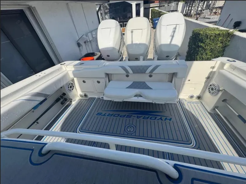 Slide: The Image of 2004 Hydra-Sports Vector 33 CC boat interior with triple engines and seating area. - 8