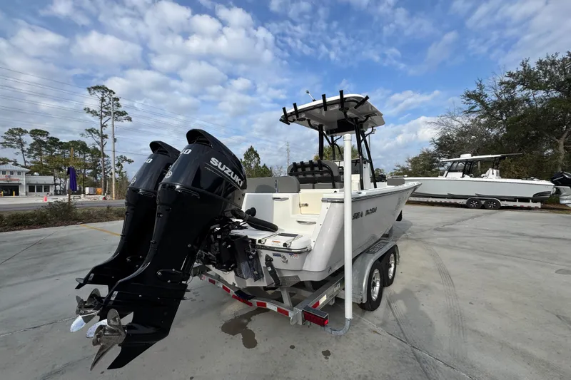 Slide: The Image of 2022 Sea Born LX24 Center Console boat with dual Suzuki engines on a trailer. - 11