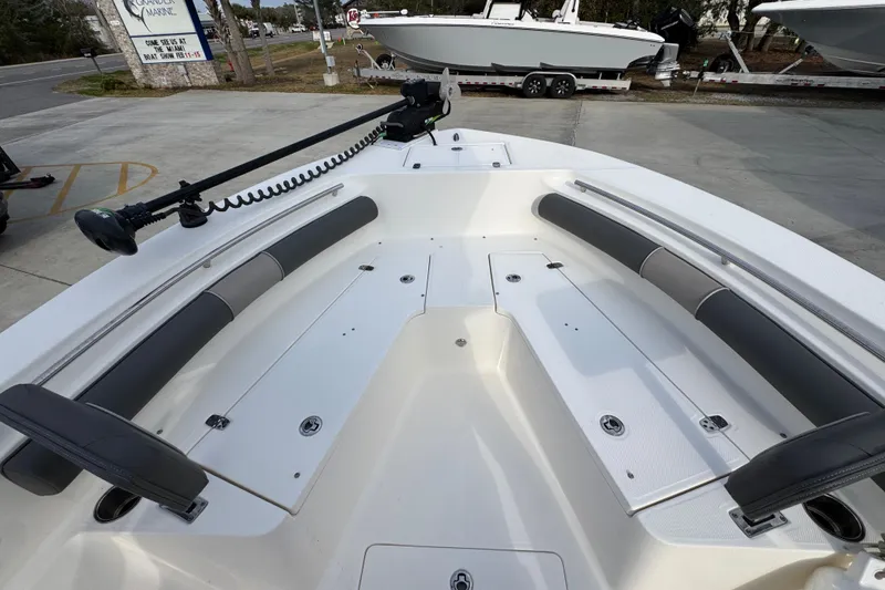 Slide: The Image of 2022 Sea Born LX24 Center Console boat interior with cushioned seating and storage compartments. - 16