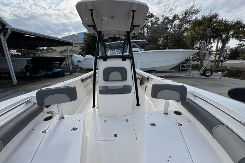 Slide: The Image of 2022 Sea Born LX24 Center Console boat with seating and storage, docked outdoors. - 21