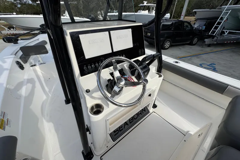 Slide: The Image of 2022 Sea Born LX24 Center Console boat interior with steering wheel and control panel. - 27