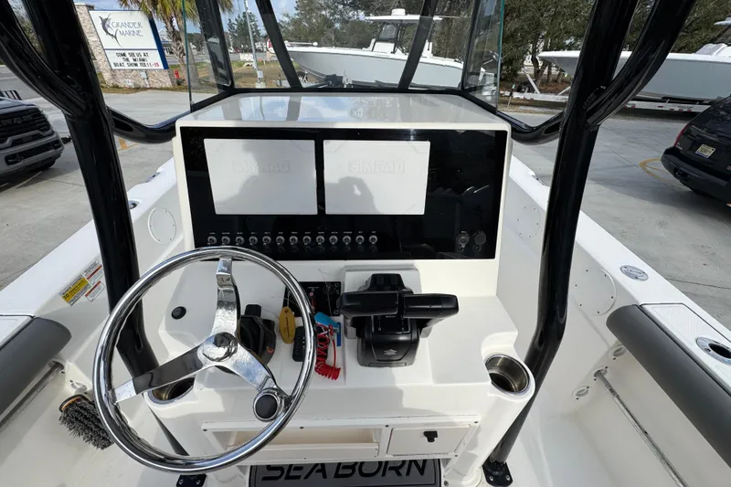 Slide: The Image of 2022 Sea Born LX24 Center Console boat dashboard with steering wheel and controls. - 28