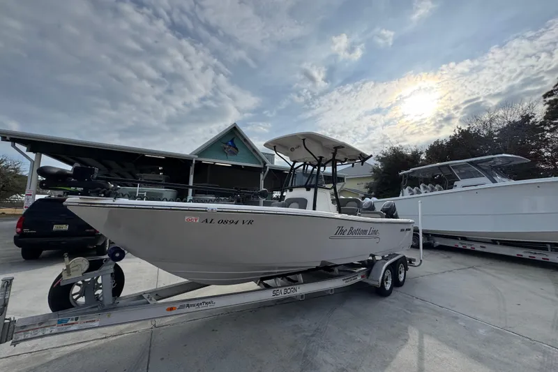 Slide: The Image of 2022 Sea Born LX24 Center Console boat on trailer under cloudy sky. - 3