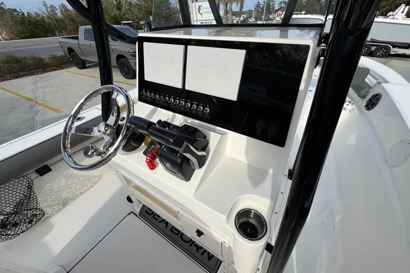 Slide: The Image of 2022 Sea Born LX24 Center Console boat dashboard with steering wheel and controls. - 30