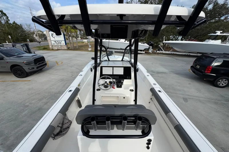 Slide: The Image of 2022 Sea Born LX24 Center Console boat in a parking lot, showcasing helm and seating area. - 32