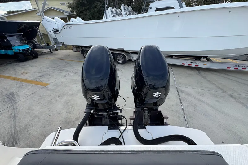 Slide: The Image of 2022 Sea Born LX24 Center Console with dual Suzuki outboard motors on a trailer. - 36