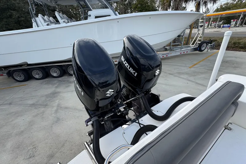 Slide: The Image of Twin Suzuki outboard engines on a 2022 Sea Born LX24 Center Console boat. - 38