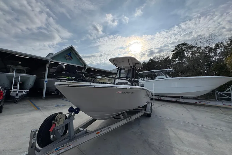 Slide: The Image of 2022 Sea Born LX24 Center Console boat on trailer under cloudy sky. - 4