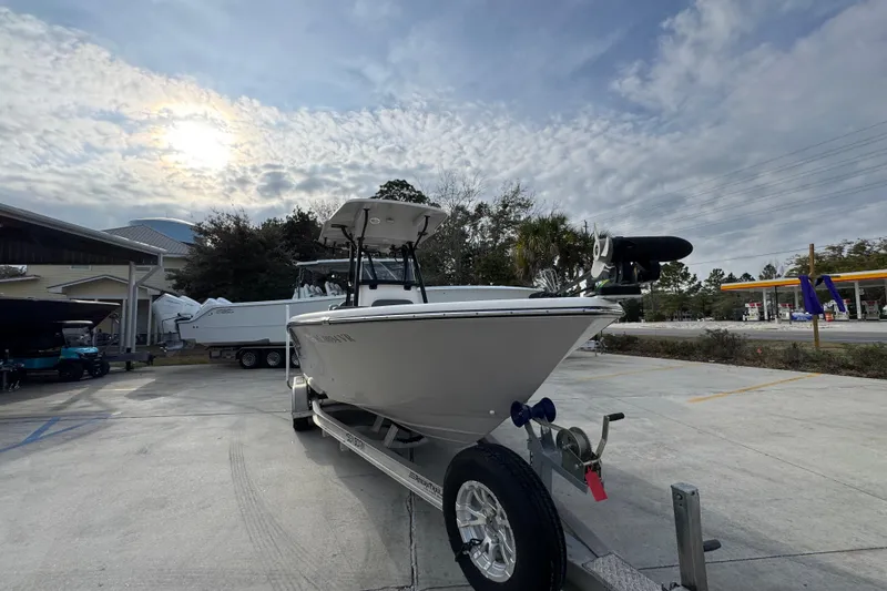 Slide: The Image of 2022 Sea Born LX24 Center Console boat on trailer under cloudy sky. - 6