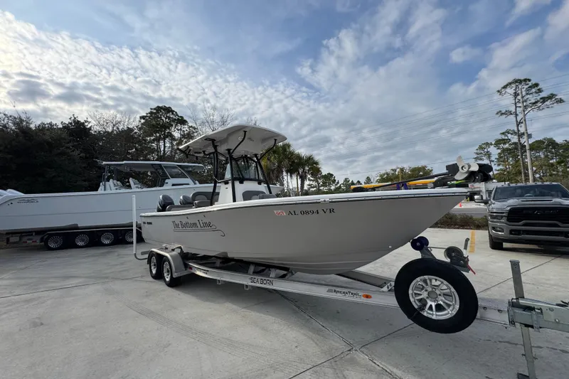 Slide: The Image of 2022 Sea Born LX24 Center Console boat on trailer under cloudy sky. - 7