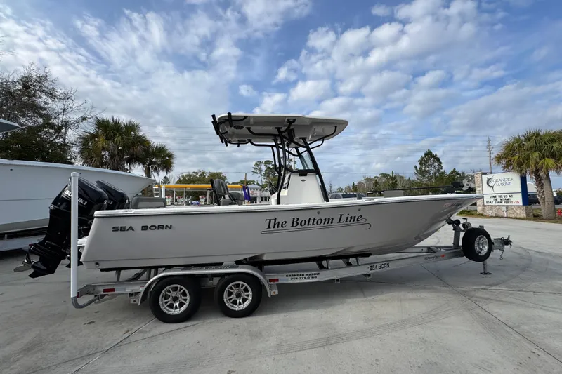 Slide: The Image of 2022 Sea Born LX24 Center Console boat on trailer under cloudy sky. - 9