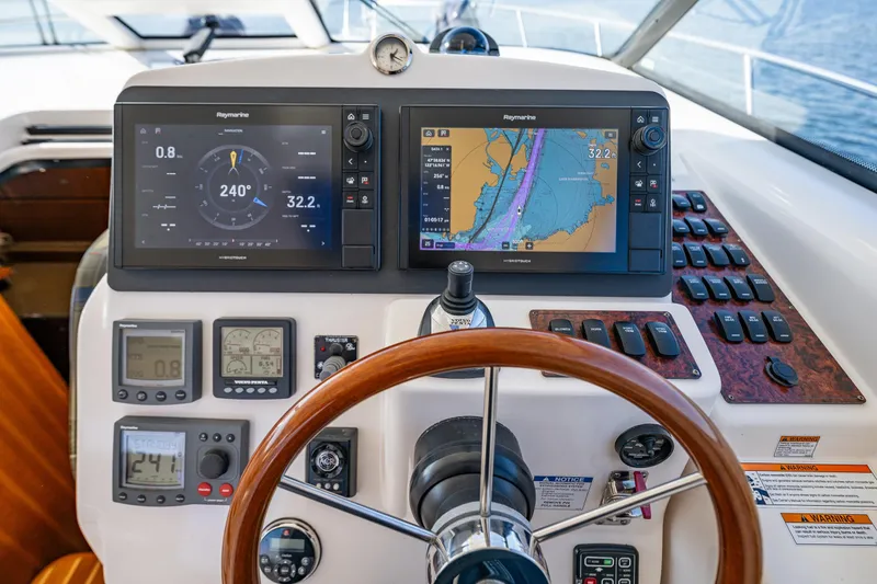 Slide: The Image of Dashboard of a 2006 Tiara Yachts 4300 Sovran with navigation displays and controls. - 14