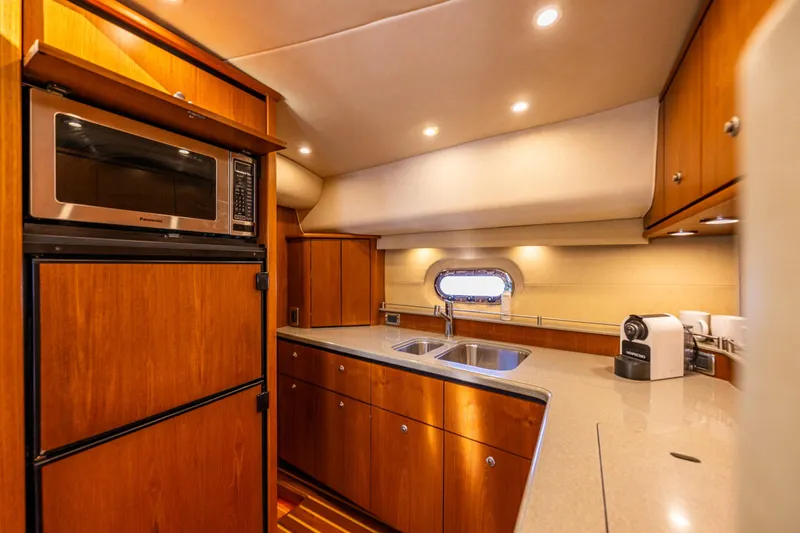 Slide: The Image of Luxurious 2006 Tiara Yachts 4300 Sovran kitchen with modern appliances and elegant wood cabinetry. - 18