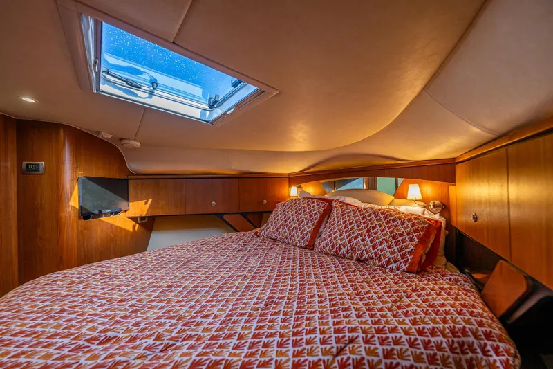Slide: The Image of Luxurious cabin interior of 2006 Tiara Yachts 4300 Sovran with cozy bedding and skylight. - 24