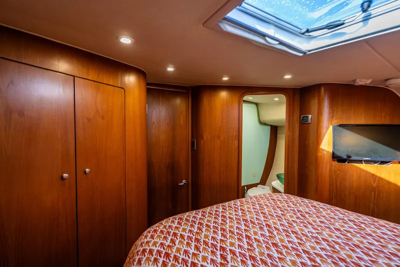 Slide: The Image of Luxurious 2006 Tiara Yachts 4300 Sovran cabin interior with wood paneling and skylight. - 25