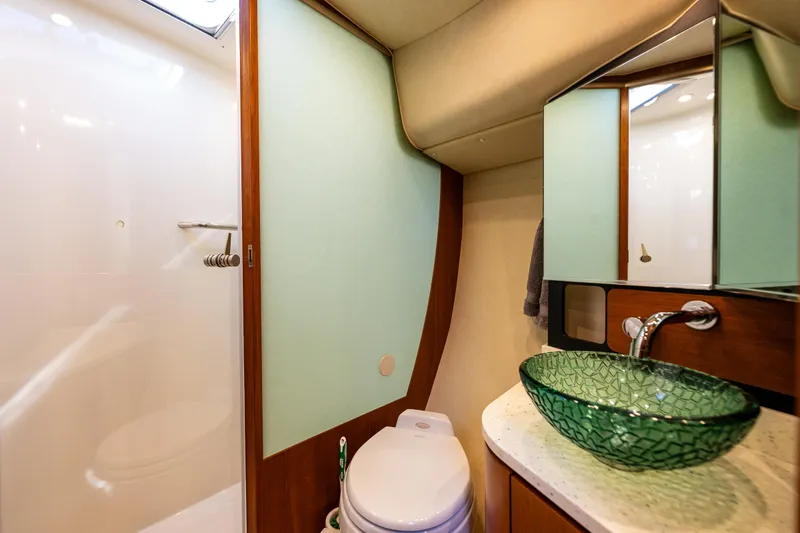 Slide: The Image of Luxurious bathroom in 2006 Tiara Yachts 4300 Sovran with modern glass sink and elegant design. - 26