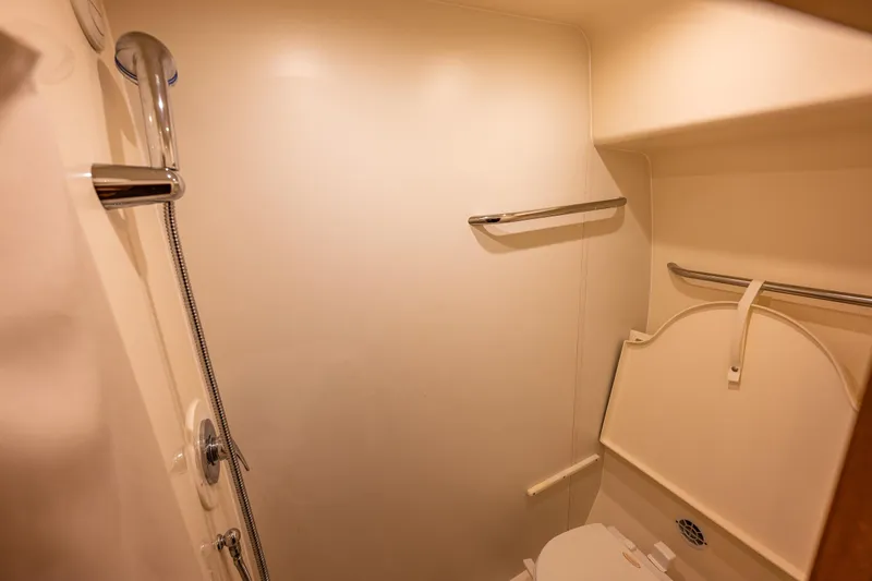 Slide: The Image of Bathroom interior of 2006 Tiara Yachts 4300 Sovran, featuring shower and toilet. - 29