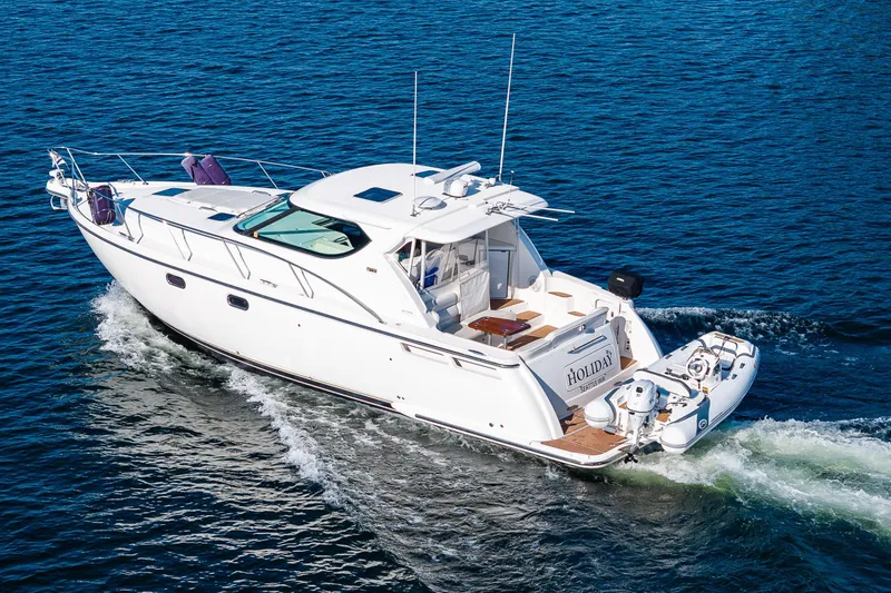 Slide: The Image of 2006 Tiara Yachts 4300 Sovran cruising on open water, rear view. - 3