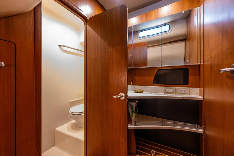Slide: The Image of Luxurious 2006 Tiara Yachts 4300 Sovran bathroom with wooden cabinetry and modern fixtures. - 30