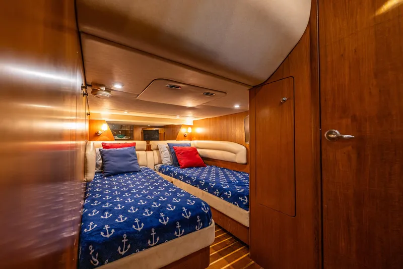 Slide: The Image of Luxurious 2006 Tiara Yachts 4300 Sovran cabin with twin beds and nautical decor. - 32