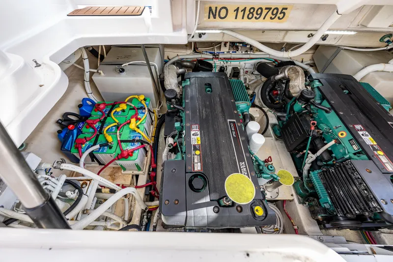 Slide: The Image of Engine room of 2006 Tiara Yachts 4300 Sovran, featuring dual engines and battery setup. - 33
