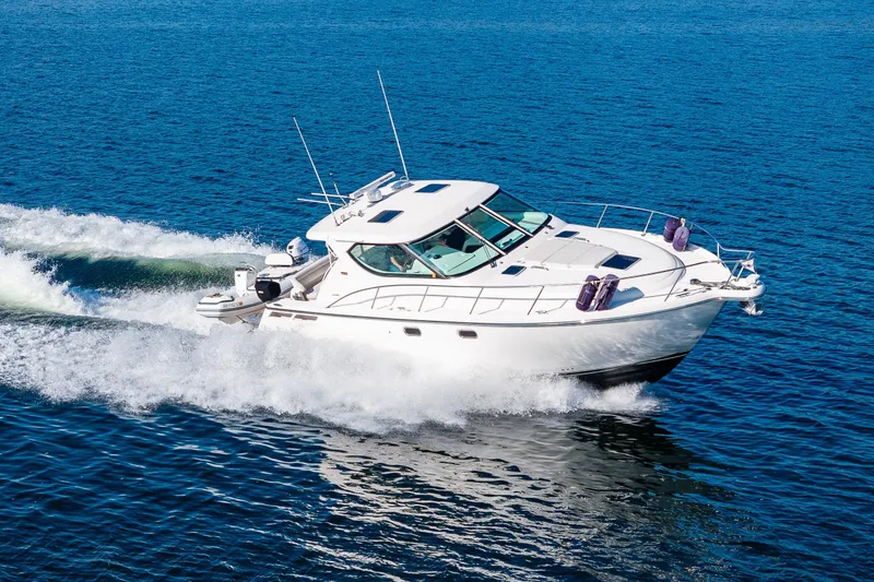Slide: The Image of 2006 Tiara Yachts 4300 Sovran cruising on open water, showcasing sleek design and performance. - 37