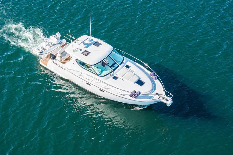 Slide: The Image of 2006 Tiara Yachts 4300 Sovran cruising on clear blue water. - 6