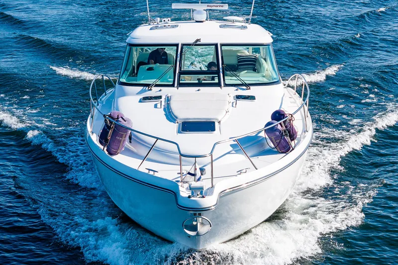 Slide: The Image of 2006 Tiara Yachts 4300 Sovran cruising on open water, front view. - 7