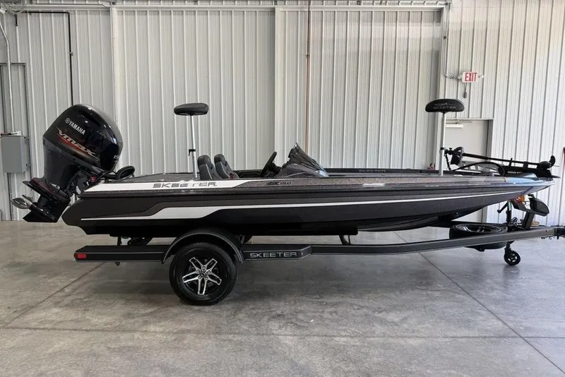 The Image of 2025 Skeeter ZX150 bass boat with Yamaha outboard motor in a garage setting. - 0