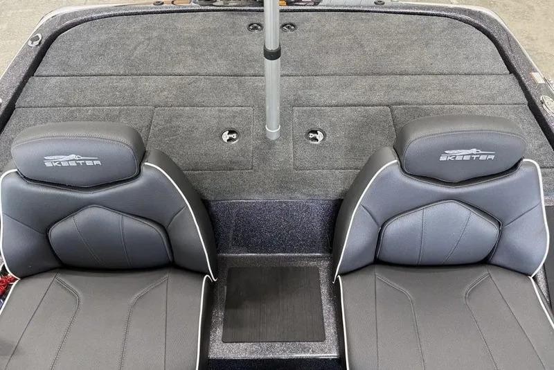Slide: The Image of 2025 Skeeter ZX150 boat interior with two gray seats and carpeted deck. - 11