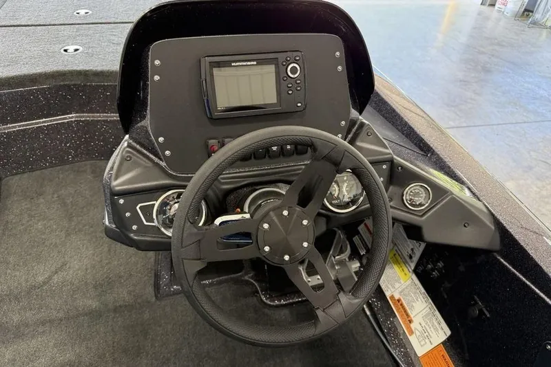 Slide: The Image of 2025 Skeeter ZX150 boat dashboard with steering wheel and electronic display. - 7