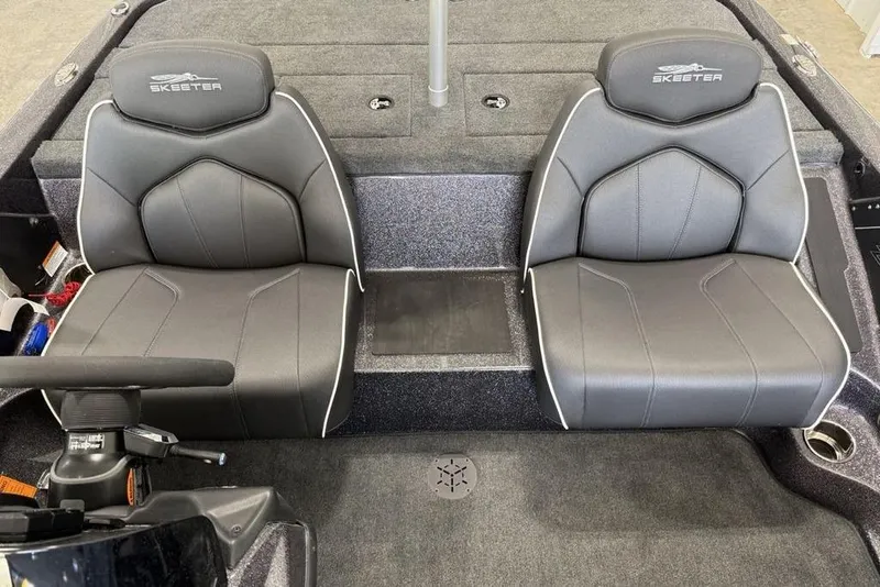 Slide: The Image of 2025 Skeeter ZX150 boat interior with two gray seats and steering console. - 9