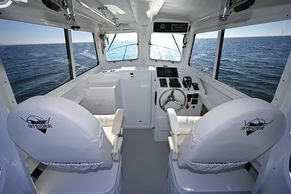 Slide: The Image of Interior of 2026 Steiger Craft 255 Miami boat with ocean view through windows. - 2