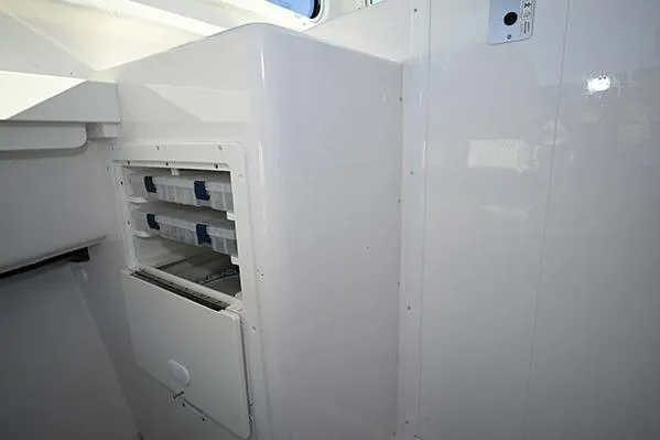 Slide: The Image of 2026 Steiger Craft 255 Miami interior storage compartment with organized shelves. - 7