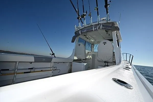 Slide: The Image of 2026 Steiger Craft 255 Miami boat with fishing rods on a sunny day at sea. - 8