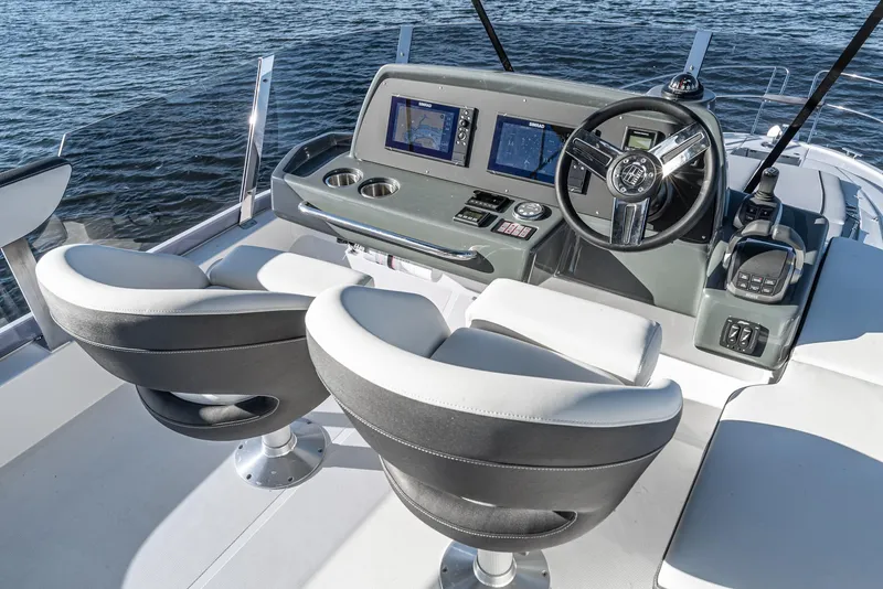 Slide: The Image of 2024 Bavaria R40 yacht cockpit with dual seats and advanced navigation system. - 26