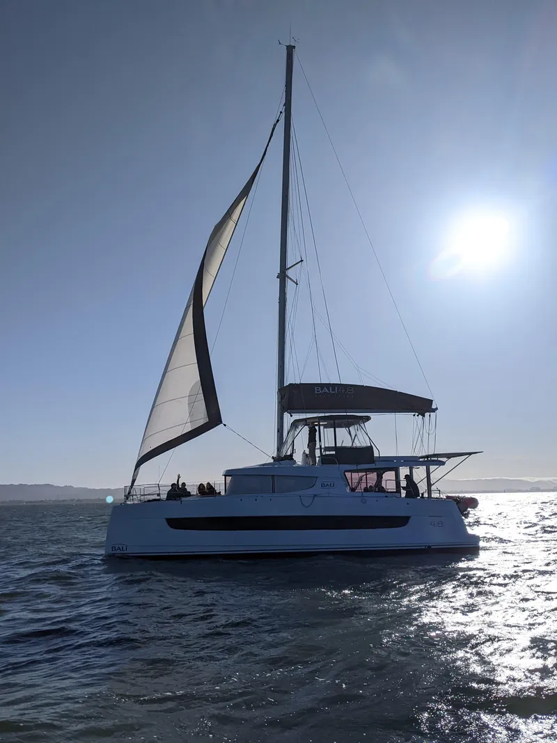 Slide: The Image of Sailing catamaran Bali 4.8, 2021 model, gliding on sunlit waters. - 3