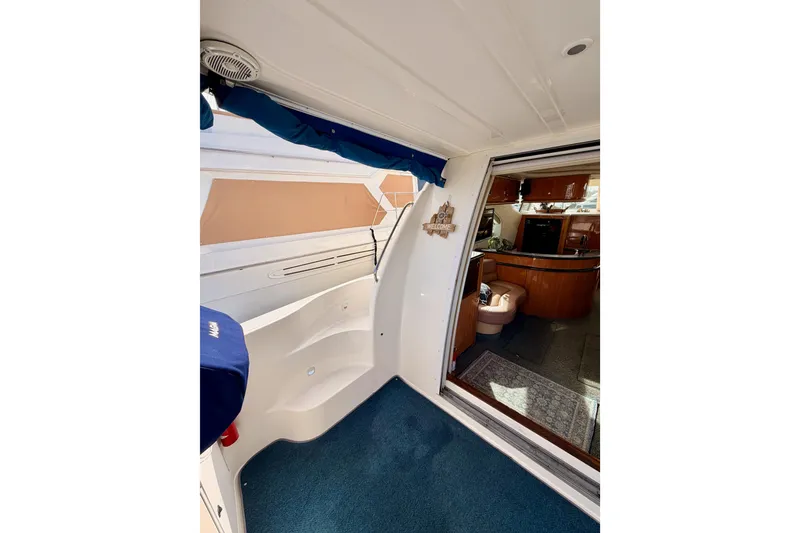 Slide: The Image of 2001 Maxum 4600 SCB Limited Edition yacht interior with blue carpet and wooden cabinetry. - 10