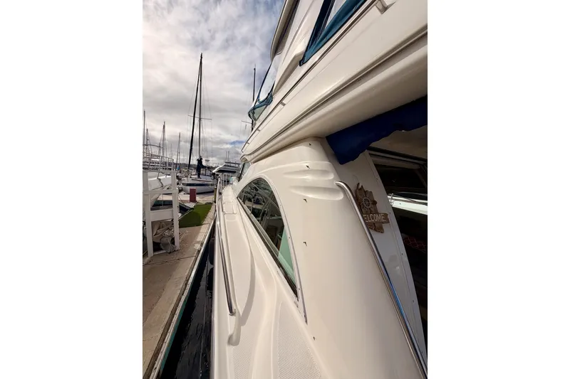 Slide: The Image of 2001 Maxum 4600 SCB Limited Edition yacht docked at marina under cloudy sky. - 11