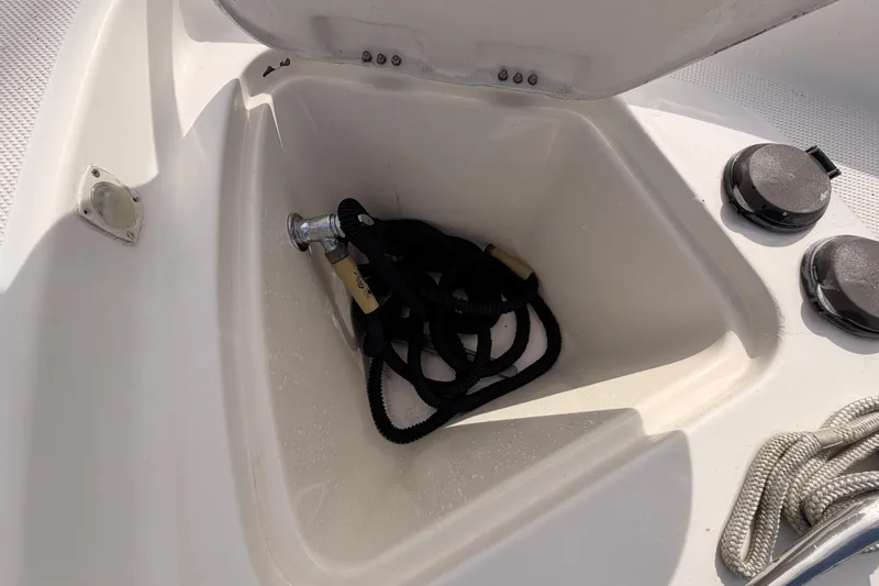 Slide: The Image of Open storage compartment on 2001 Maxum 4600 SCB Limited Edition boat with coiled rope. - 16