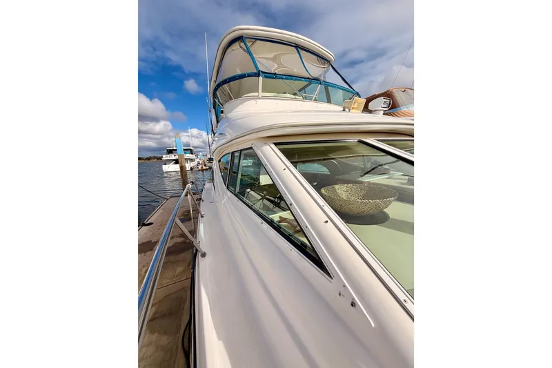 Slide: The Image of 2001 Maxum 4600 SCB Limited Edition yacht docked under a blue sky. - 20