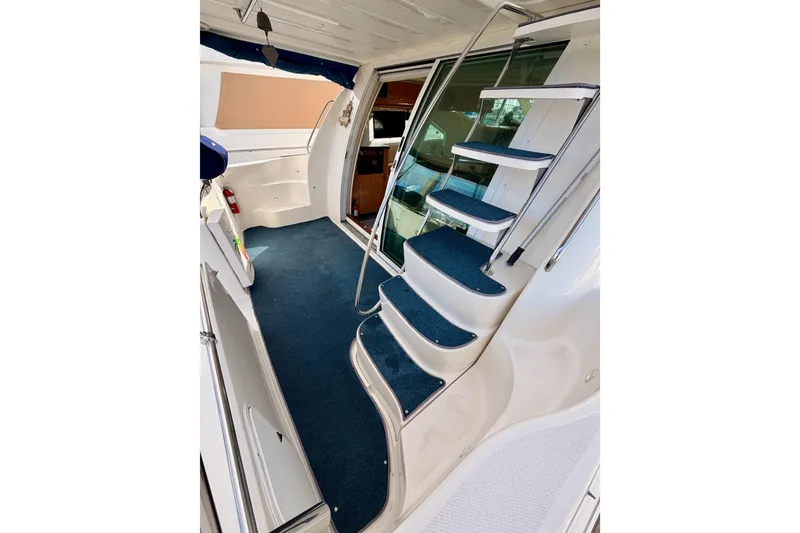 Slide: The Image of Interior view of 2001 Maxum 4600 SCB Limited Edition yacht with blue-carpeted stairs. - 22