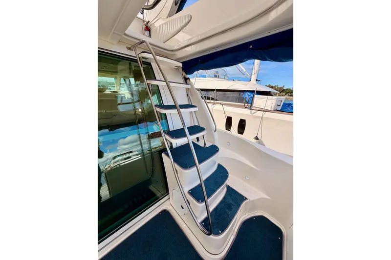 Slide: The Image of Staircase on 2001 Maxum 4600 SCB Limited Edition yacht with blue carpet and metal railing. - 23