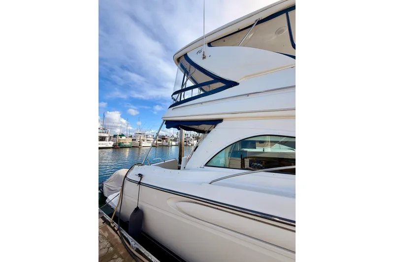 Slide: The Image of 2001 Maxum 4600 SCB Limited Edition yacht docked at marina under blue sky. - 4