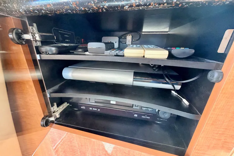 Slide: The Image of Electronics cabinet in 2001 Maxum 4600 SCB Limited Edition yacht with remotes and devices. - 42